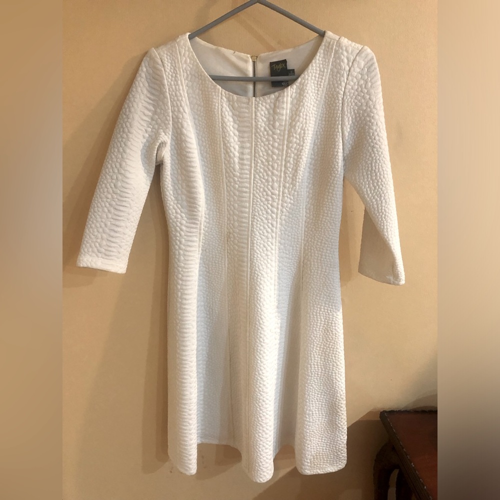 Taylor 3/4 length sleeve white dress with slight drop waist and zipper. Size 2.